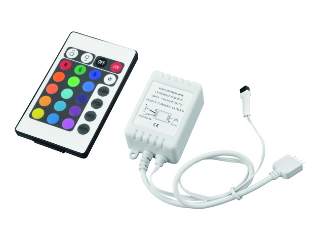 A white box with cables coming out from it, with a remote with colored buttons next to it.